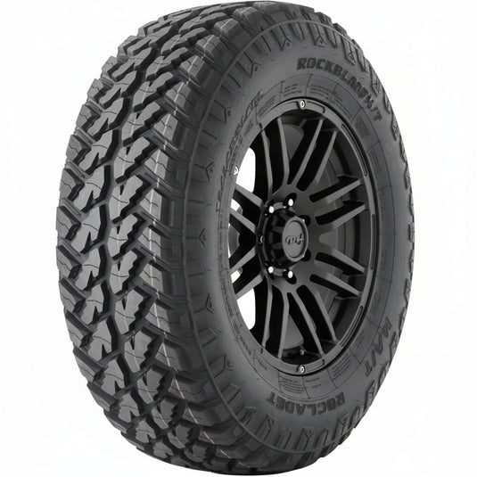 A single black all-terrain tire with deep, aggressive tread blocks, shown upright against a plain white background. The sidewall features embossed branding and text including 'ROCKY RAINIER'.